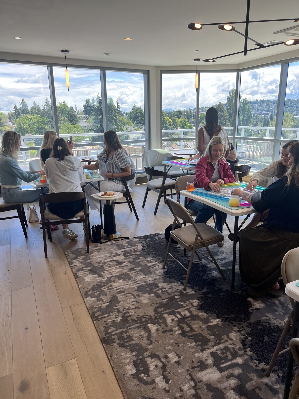 Women playing mahjong at a table by the windows
