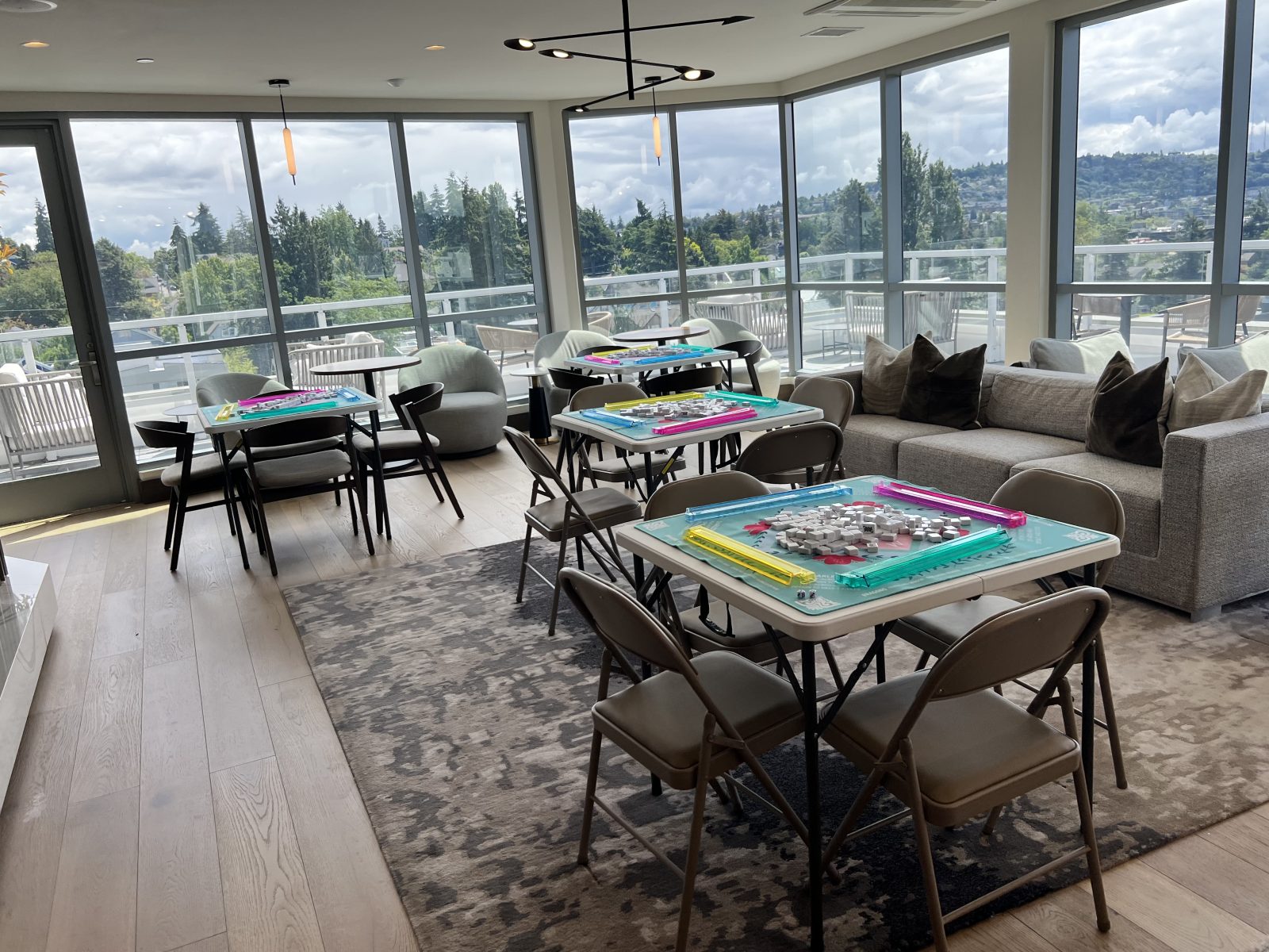 Folding tables set with colorful racks, the lake and hills beyond the glass